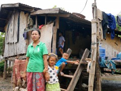 Subsistence farmer, Kaum, with her children in Phonethong Village